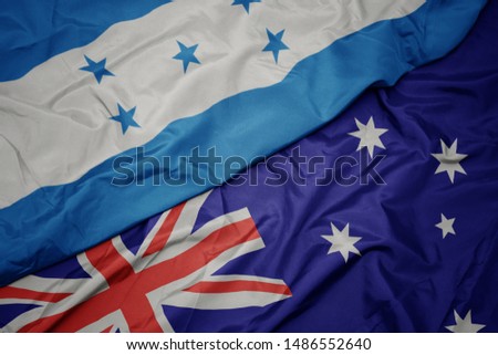 waving colorful flag of australia and national flag of honduras. macro