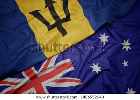 waving colorful flag of australia and national flag of barbados. macro