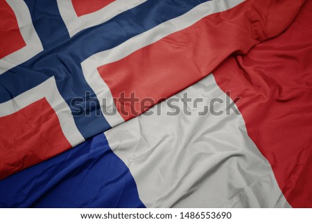 waving colorful flag of france and national flag of norway. macro