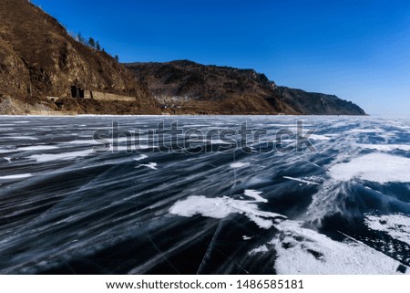 Frozen Lake Baikal. Beautiful mountain near the ice surface on a frosty day. Natural background. Russia. Siberia