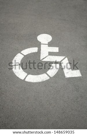white sign for handicapped who indicates parking space