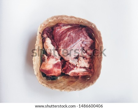 Lamb raw meat in the bamboo plate or besek at the Feast of Qurban during Eid Al Adha Al Mubarak isolated on white background.  Royalty-Free Stock Photo #1486600406
