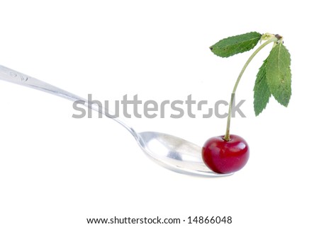 red cherry in silver spoon