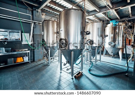 Fermentation mash vats or boiler tanks in a brewery factory. Brewery plant interior.  Royalty-Free Stock Photo #1486607090
