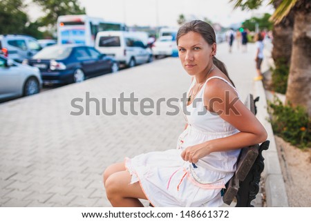 A girl sits on a bench. Summer  photo-shoot