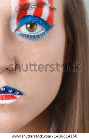 America flag painted on the half of a face of a girl. Constitution Day and Citizenship Day of USA