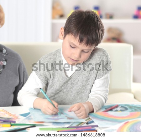 modern grandparents watch as their grandson draws