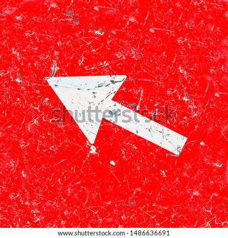 Old damaged and scratched metal road sign with white arrow on red background - concept image.