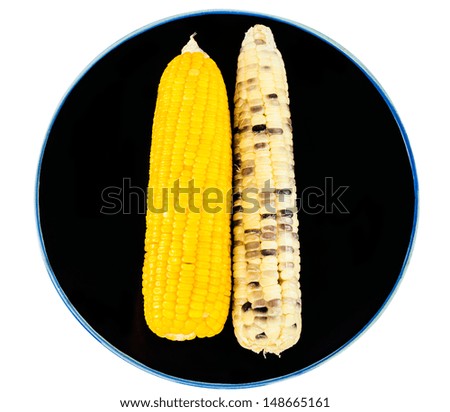 Two type of boiled corns on black plate
