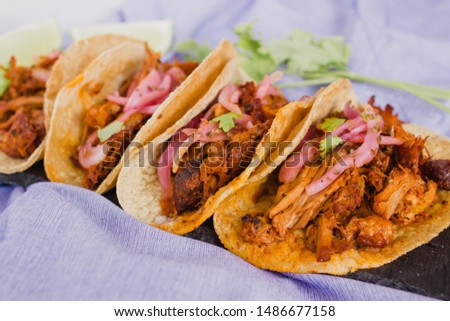 Tacos filled with cochinita pibil. Authentic mexican tacos from Yucatan, Mexico. Organic, natural background. Taco tuesday.