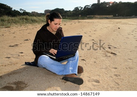 woman working with laptop on the coast