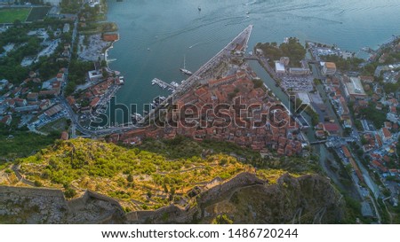 Panoramic aerial view of the red tiled roofs of the old town of Kotor and Kotor Bay