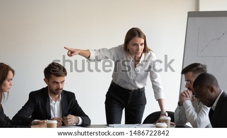 Angry caucasian white female boss manager shout firing sad stressed african american male worker intern at team office meeting, racial discrimination at work, harassment racism at workplace concept Royalty-Free Stock Photo #1486722842