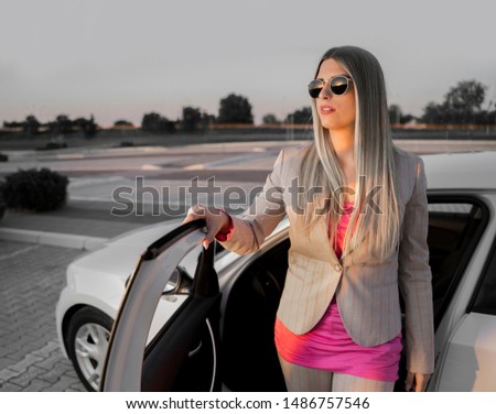 portrait Stylish woman getting out of the car 