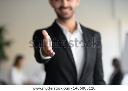 Professional business man hr consultant salesman wear suit extending hand at camera for handshake greeting offering cooperation, welcoming for collaboration, introduction concept, close up view Royalty-Free Stock Photo #1486805120