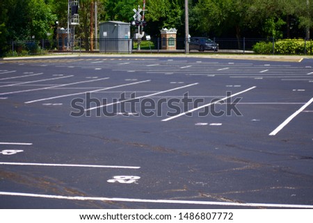 Empty railroad parking lot in rural town Royalty-Free Stock Photo #1486807772
