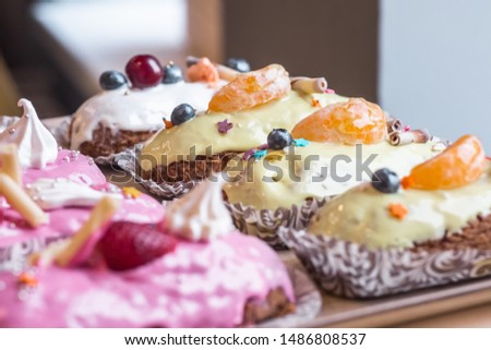 three eclairs with custard in a bakery