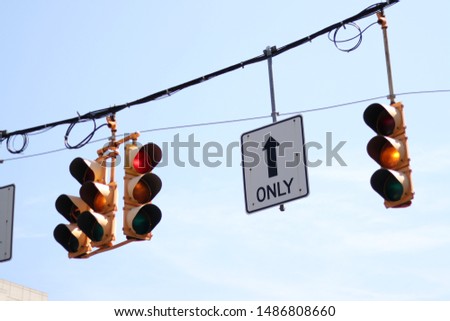 Albany, USA, indicator lamps hanging with a one way only sign at a junction.