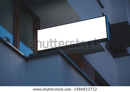Mock up of illuminated blank signboard in the night. Place for text, outdoor advertising, banner or public information.
