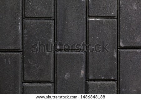 Rough dark grey brick wall background or texture