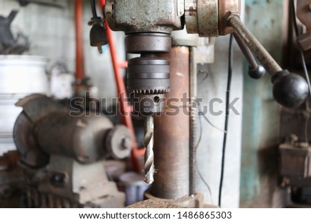 drilling machine head in garage.