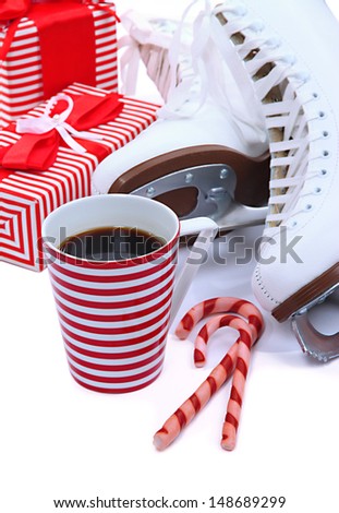 Figure skates with cup of coffee isolated on white