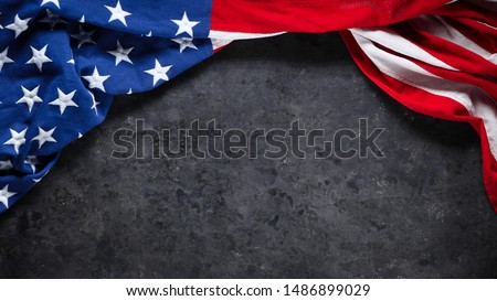 US American flag on worn black background. For USA Memorial day, Veteran's day, Labor day, or 4th of July celebration. With blank space for text. Royalty-Free Stock Photo #1486899029