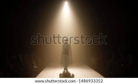Man on Fashion runway out of focus,blur background