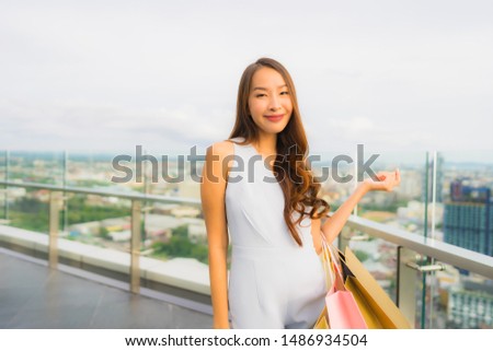 Portrait beautiful young asian woman happy and smile with shopping bag from department store mall