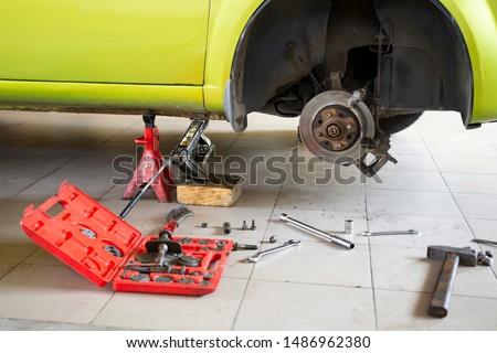 Tool for repairing a car on the floor, replacing car parts