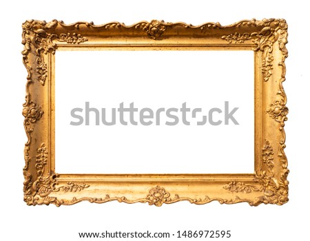 old wide ornamental baroque picture frame painted in gold color cutout on white background