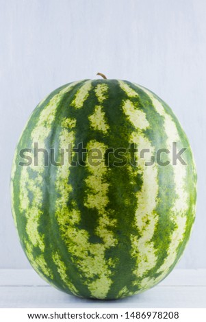 Watermelon on natural white background. Whole watermelon on wooden background. Healthy food for vegan. Copy space