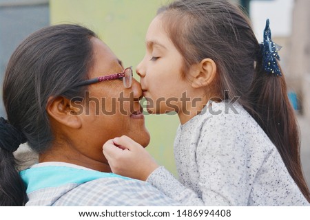 Tender portrait of native american woman with her little daughter. Royalty-Free Stock Photo #1486994408