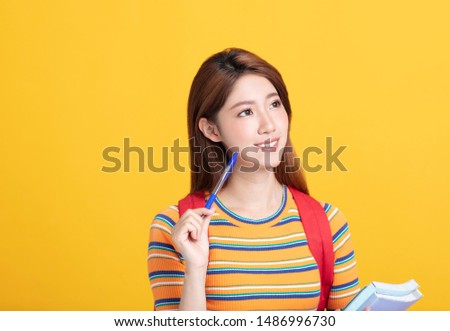 Portrait of beautiful asian  student holding books 