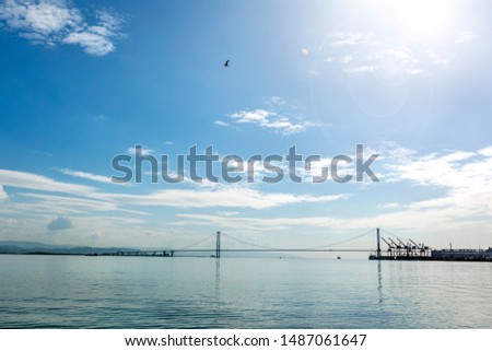 View of the Izmit Gulf and the suspension bridge with cloudy and sunny sky. The bridge links the Turkish city of Gebze to the Yalova Province and carries the O-5 motorway across the gulf.