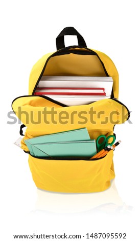 Backpack with different school stationery. Isolated on white background. Back to school concept photo.