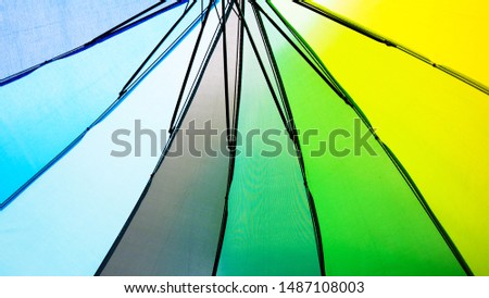 Abstract background with green, yellow and blue of umbrellas.