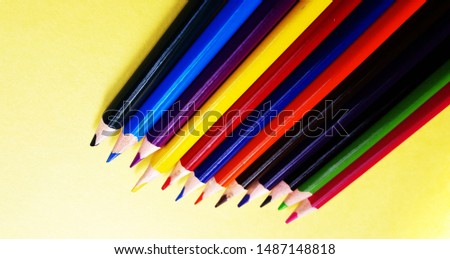 color pencils isolated on yellow background