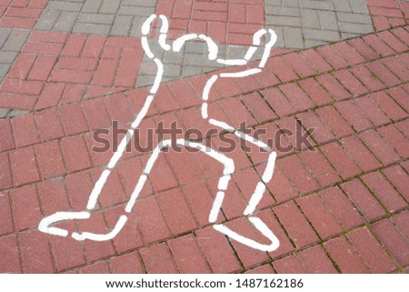silhouette of a drawn man on the sidewalk