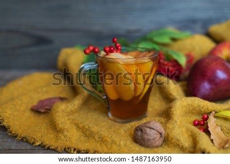 Cup of autumn tea and yellow dry leaves. Hot drink for autumn cold rainy days. Concept autumn mood.