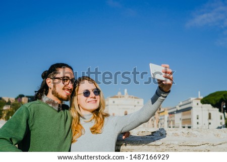Happy young couple in love taking selfie self-portrait outside. Nice old town. Happy couple.