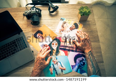 Photographer in his studio choosing photos for friends. Hipster man working for the next editing images. Technology concept - Image.