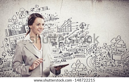 Image of young businesswoman holding ipad against sketch background