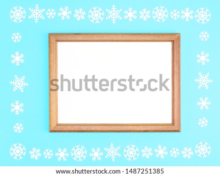 Snowflakes and frame on a blue background. Christmas and New Year concept