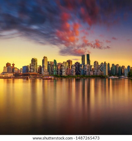 Sunset skyline of Vancouver downtown as seen from Stanley Park, British Columbia, Canada. Long exposure.