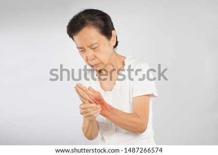 old asian woman hand muscle pain