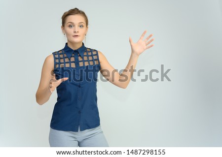 Studio photo a waist-high portrait of a pretty young woman girl in a business suit on a white background. He stands right in front of the camera, explains, with emotion.