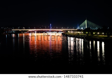 A reflection of the lights at night on the Sava river in Belgrade