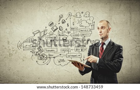 Image of young businessman holding ipad against sketch background