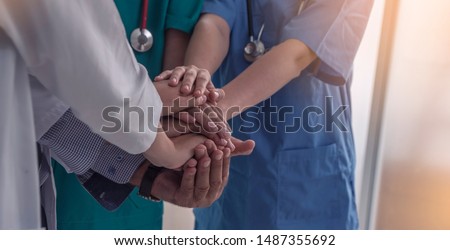 Group of doctors and nurses standing and join hand together staff in the hospital,International, profession, people and medicine concept 